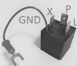 A black electrical relay with a ground lead, labeled with terminal markings GND, X, P, and L on a plain light background.